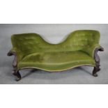 A Victorian mahogany double chair end sofa in buttoned upholstery on carved cabriole supports. H.