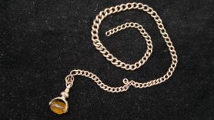 A 9ct graduated curb link 9 carat rose gold Albert chain and rolled gold swivel fob. Each link