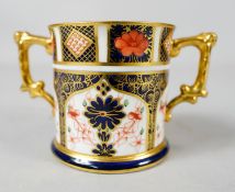 A Royal Crown Derby 1128 pattern Imari twin handled porcelain hand painted mug. Makers mark to the