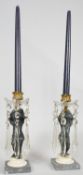 A pair of 19th century candelabras with gilt metal mounts and putti holding the flame aloft with cut