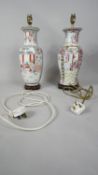 Two hand painted Chinese porcelain vases converted into lamps, each mounted on a wooden base. One