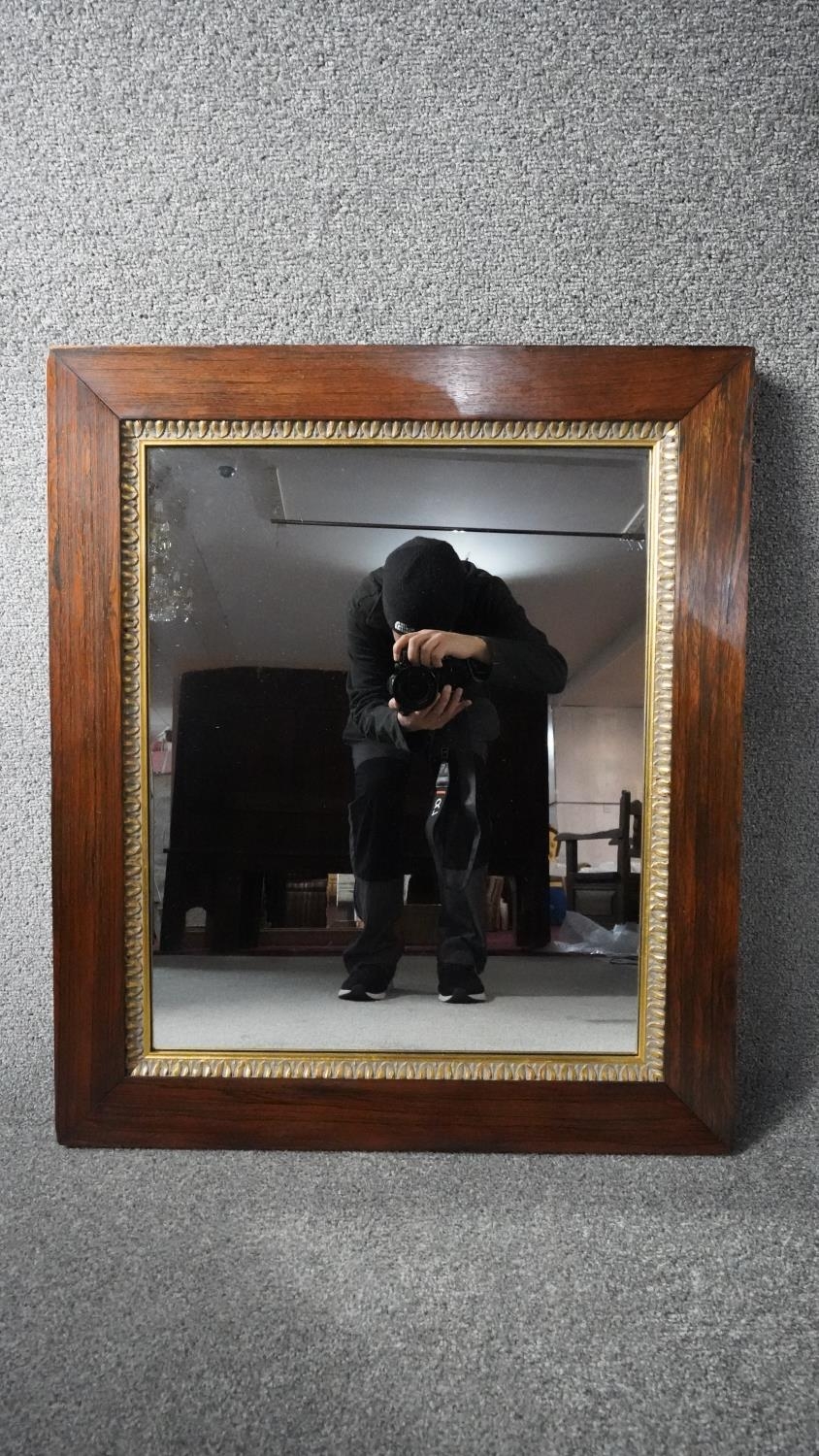 A late 19th century wall mirror in rosewood frame with gilt acanthus carved slip. H.74 W.63