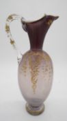 A 19th century Bohemian opalescent mauve glass jug with gilded floral and foliate design. H.25 W.13