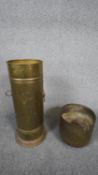 Two brass items. Including a brass cylindrical stick stand with lion head handles and an antique