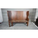 A C.1900 high backed pitch pine settle on square supports. H.128 W.161 D.57