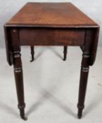 A 19th century mahogany drop flap Pembroke table with frieze drawer on turned tapering supports