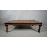 An Indian hardwood metal bound and studded low table on circular supports. H.46 W.102 D.92