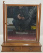 An Eastern teak swing toilet mirror on platform base fitted with drawers. H.66 W.52cm