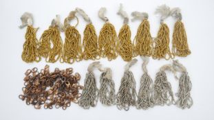 Fifteen bunches of vintage bright cut gold and silvered coloured seed beads along with a bag of