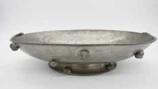 An Italian Peltro hammered pewter oval pedestal dish with sea shell handles and relief shell