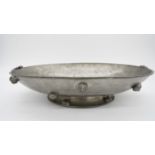 An Italian Peltro hammered pewter oval pedestal dish with sea shell handles and relief shell