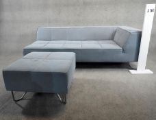 A contemporary corner sofa in piped and stitched upholstery raised on metal tubular supports along