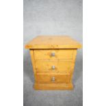 An Art Deco style burr walnut pedestal chest of three drawers on plinth base. H.48