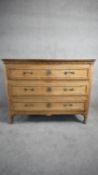 A late 19th century French oak three drawer commode raised on facetted tapering supports. H.94 W.122