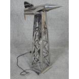 A vintage chrome metal rocket lamp on launch column, pierced geometric design. H.70cm