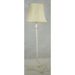A mid century vintage painted wrought metal lamp standard on twist stem and tripod shaped and