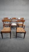 A mid 19th century set of five mahogany bar back dining chairs with drop in seats above turned