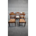 A mid 19th century set of five mahogany bar back dining chairs with drop in seats above turned