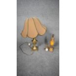 An antique marble and gilt metal table along with a brass twin handled table lamp on four lion paw