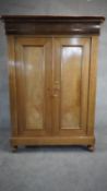 A late 19th century French Provincial chestnut linen cupboard with upper frieze drawer above fielded