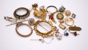 A collection of brooch settings, badges, odd earrings, pendants and other jewellery findings.