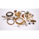 A collection of brooch settings, badges, odd earrings, pendants and other jewellery findings.