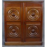 A 19th century Colonial teak dwarf cabinet with circular moulded panels and flowerhead roundels to