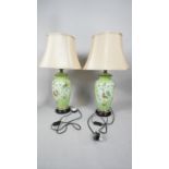 A pair of contemporary Chinese style green ceramic vase table lamps hand decorated with vines,