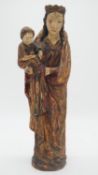 An antique painted wooden figure of Madonna and child with gilded details H.50cm