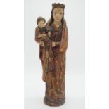 An antique painted wooden figure of Madonna and child with gilded details H.50cm