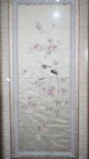 A framed and glazed antique Chinese silk embroidery panel with a parrot sitting in a flowering