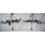 A pair of wrought iron ceiling hanging chandeliers each with nine candle sconces. H.105 W.110
