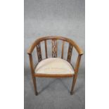 An Edwardian mahogany and satinwood inlaid armchair on square tapering supports terminating in spade