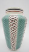 A Poole Pottery freeform vase of cylindrical tapering form decorated in the PKT pattern, designed by