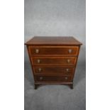 A Georgian style mahogany and satinwood crossbanded small chest of four drawers on swept bracket