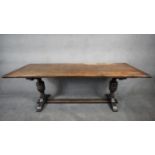 A Jacobean style oak refectory dining table with planked top and cleated ends on stretchered