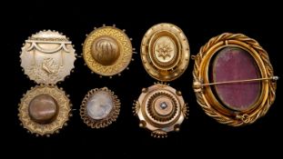 A collection of seven rolled gold Victorian brooches. Including six mourning brooches (2 pins
