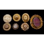 A collection of seven rolled gold Victorian brooches. Including six mourning brooches (2 pins