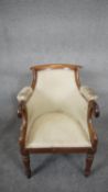 A William IV mahogany framed tub shaped library armchair raised on acanthus carved tapering