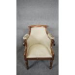 A William IV mahogany framed tub shaped library armchair raised on acanthus carved tapering