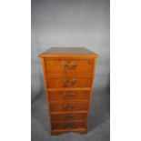 A Georgian style yew wood filing cabinet fitted with three deep drawers. H.110