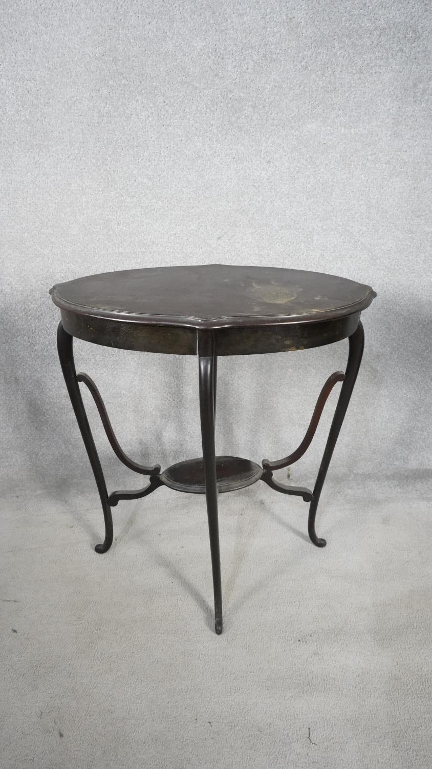 A late 19th century mahogany shaped oval top occasional table on slender cabriole supports united by