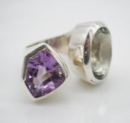 A bespoke sculptural wrap around silver and amethyst ring. One side set with an oval mixed cut green