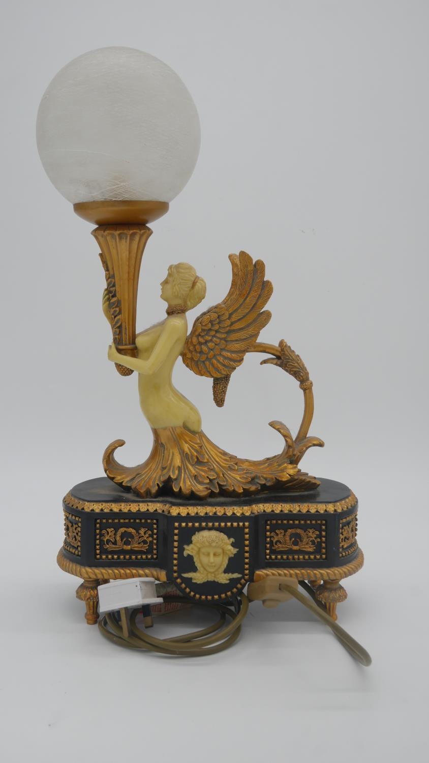 A gilded resin contemporary light in the style of a French ormolu candlestick, with frosted glass