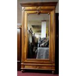 A late 19th century French walnut armoire with mirrored door and base drawer on turned tapering