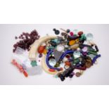 A large collection of loose gemstones and other minerals. Including coral beads, antique ivory