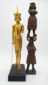 An antique Continental carved wooden candlestick in the form of two figures along with a gilded