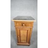 A late 19th century French walnut pedestal cabinet with marble top above frieze drawer and panel