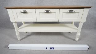 A small painted dresser with planked top above drawers on turned supports united by an under tier.
