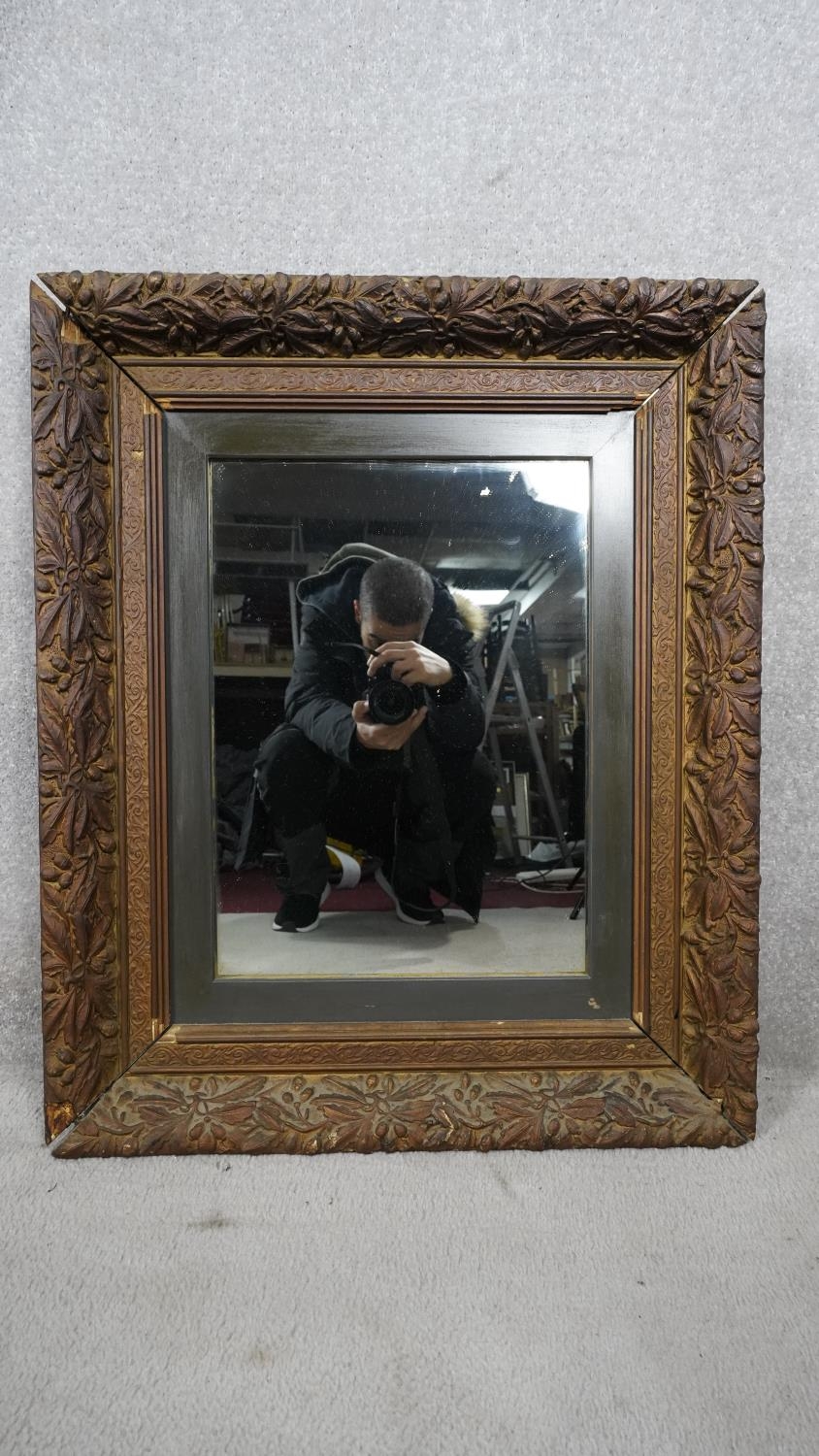 A 19th century giltwood wall mirror in floral gesso decorated frame. H.80 W.64